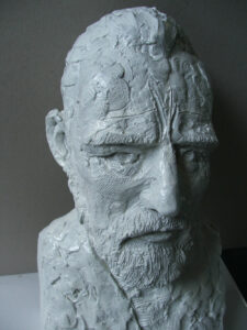 A Vincent Bust, created by Master Sculptor Robert C Hitchcock, portrays a white bust of a man with a beard. Bronze Sculpture by Artist and Master Sculptor Robert C Hitchcock