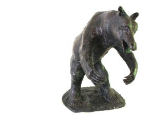 A Bear Sculpture of a bear standing on a white background created by Master Sculptor Robert C Hitchcock. Bronze Sculpture by Artist and Master Sculptor Robert C Hitchcock