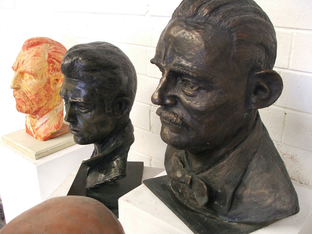 Multiple bronze and bronze-coloured resin protrait busts of historical figues by Wester Australian sculptor, Robert C Hitchcock in his Morley studio