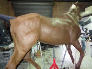 A bronze sculpture of a Life-Size Horse is being created by artist and master sculptor Robert C Hitchcock in his workshop. Bronze Sculpture by Artist and Master Sculptor Robert C Hitchcock