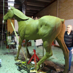 Master Sculptor Robert C Hitchcock standing next to a Life-Size Horse in his workshop. Bronze Sculpture by Artist and Master Sculptor Robert C Hitchcock