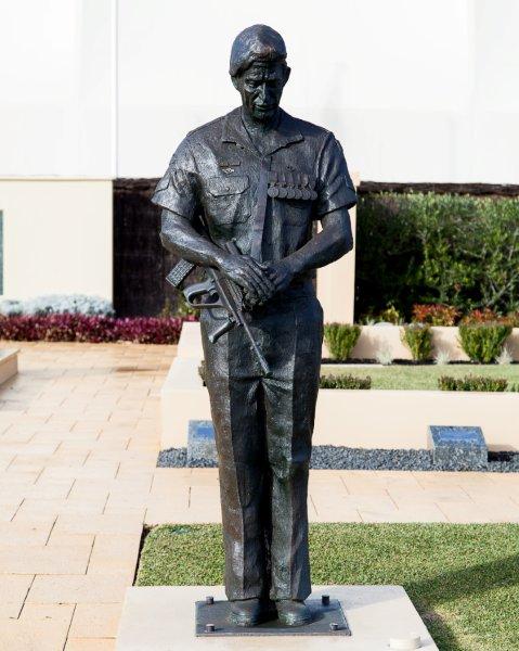 A bronze statue of a soldier holding a gun.