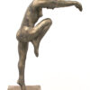A bronze sculpture of a woman in a pose.