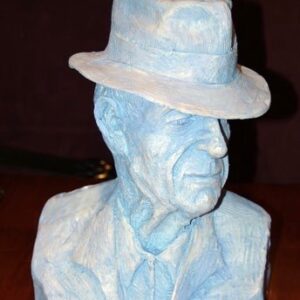 A blue bust of a man wearing a hat.