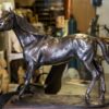 A Northerly | Contemporary Sculpture by Robert C Hitchcock bronze statue of a horse in a workshop.