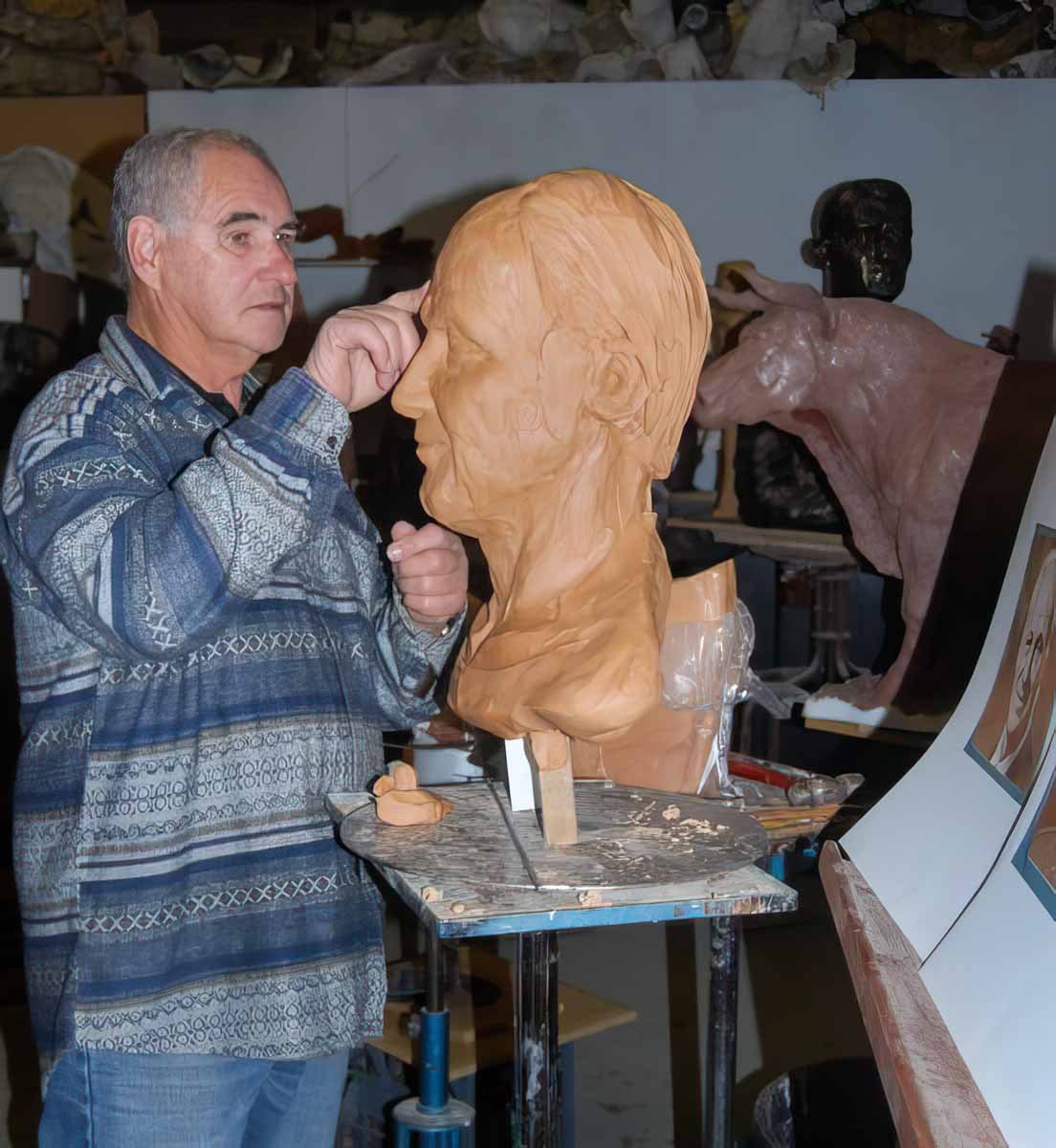 Robert C Hitchcock - Sculptor -Working in Clay on portrait bust in his studio